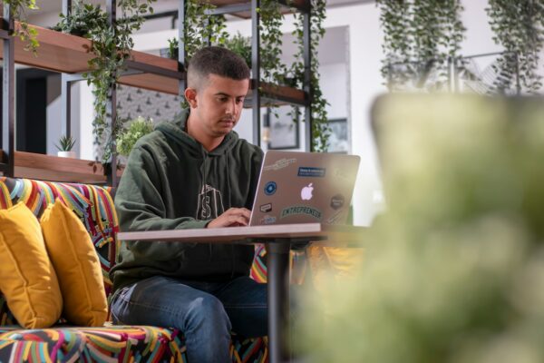 a man sitting on a couch with a laptop